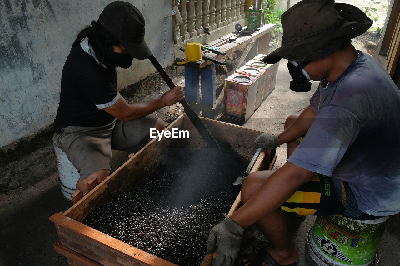 HIGH ANGLE VIEW OF MEN AND PEOPLE IN KITCHEN