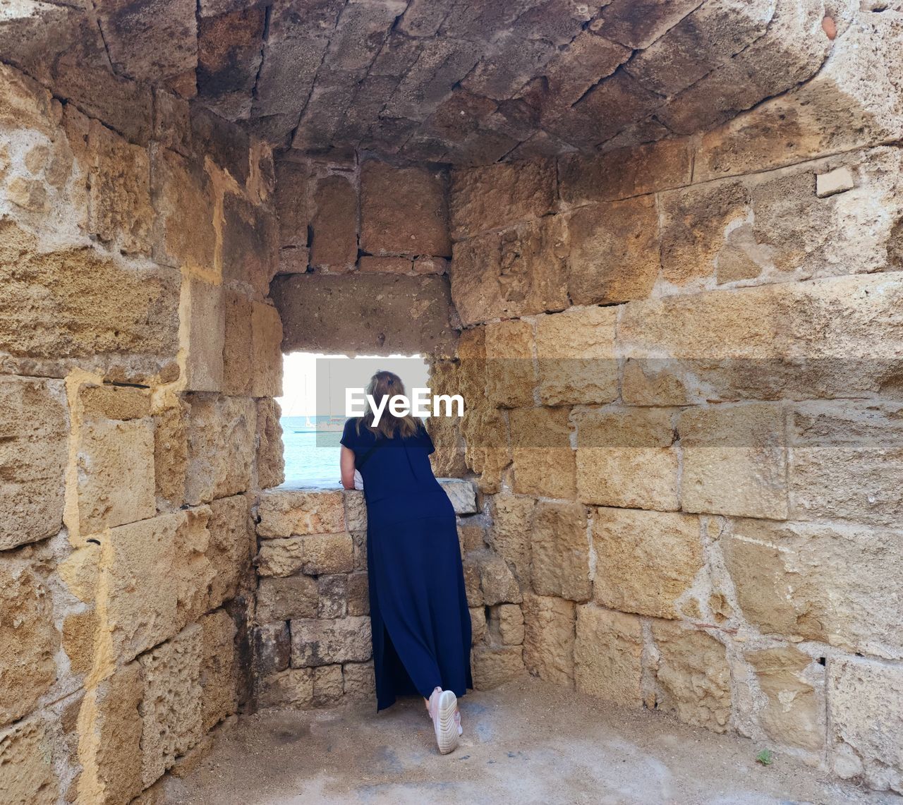 rear view of man standing against rock