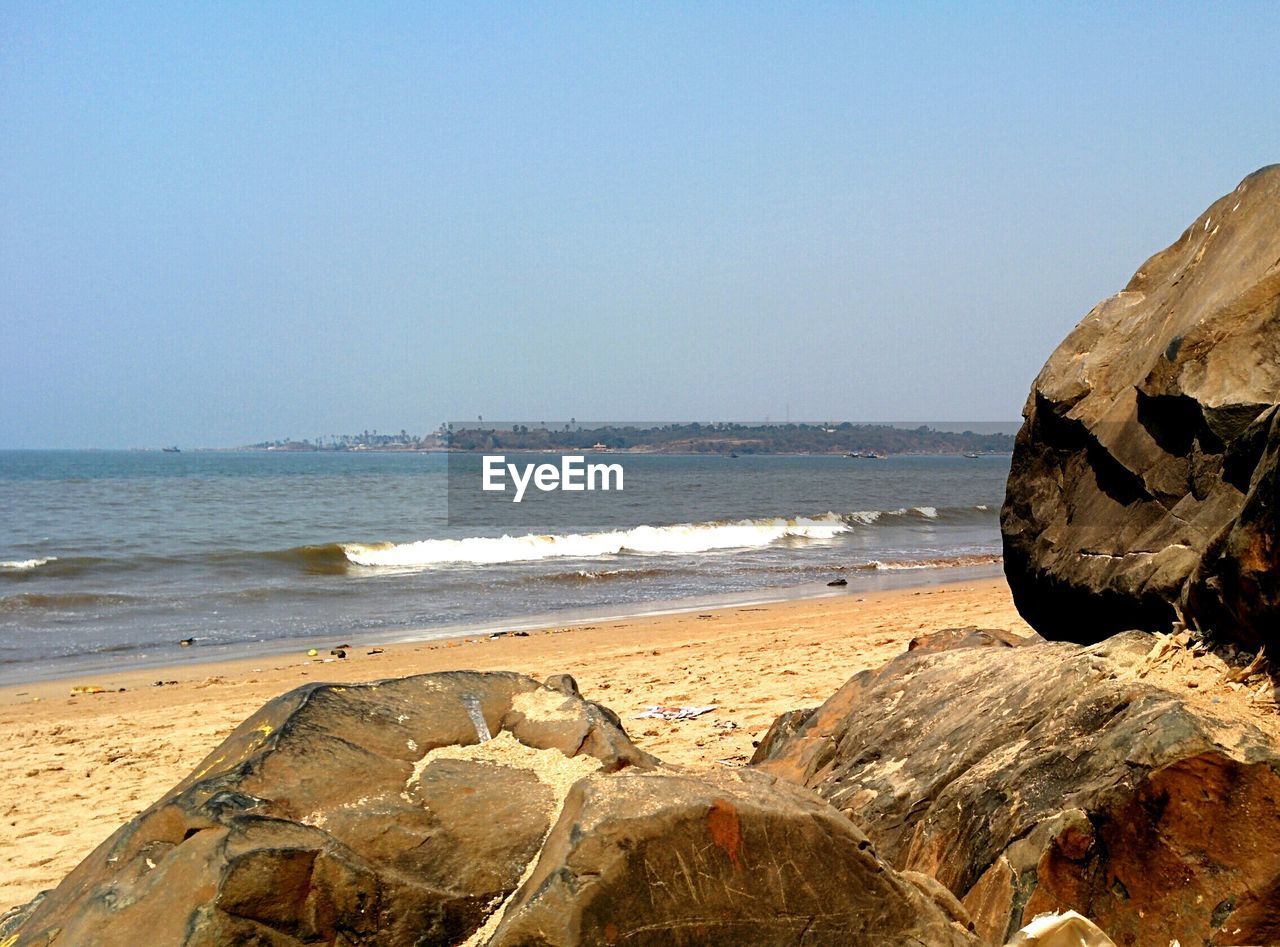 Scenic view of beach against clear sky