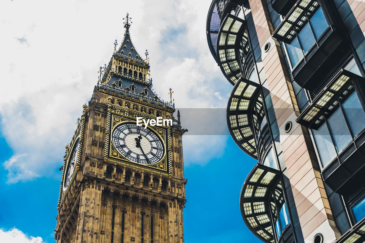 Low angle view of clock tower against sky