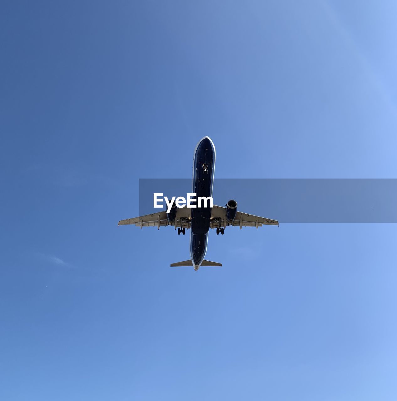 LOW ANGLE VIEW OF AIRPLANE FLYING IN SKY