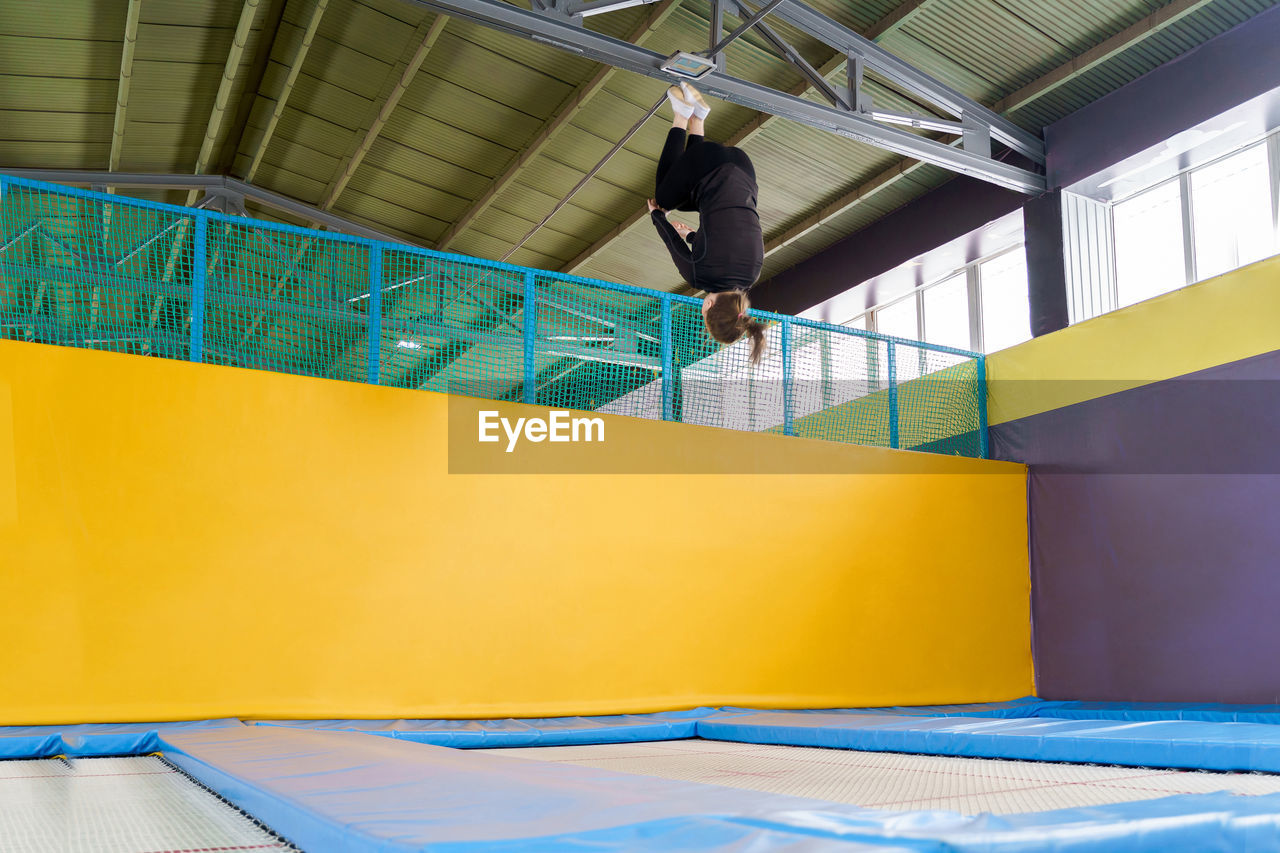 Low angle view of man walking on staircase