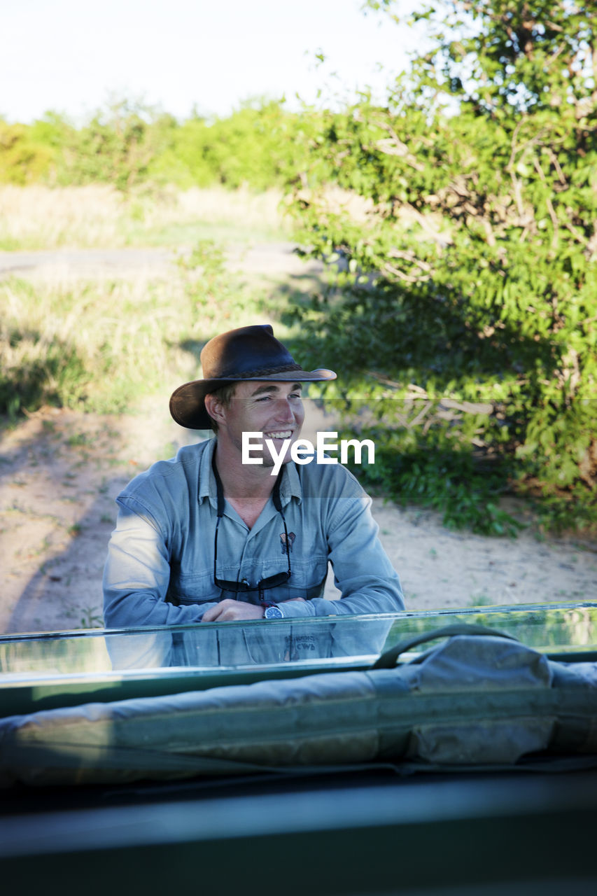 Traveler in front of off-road car