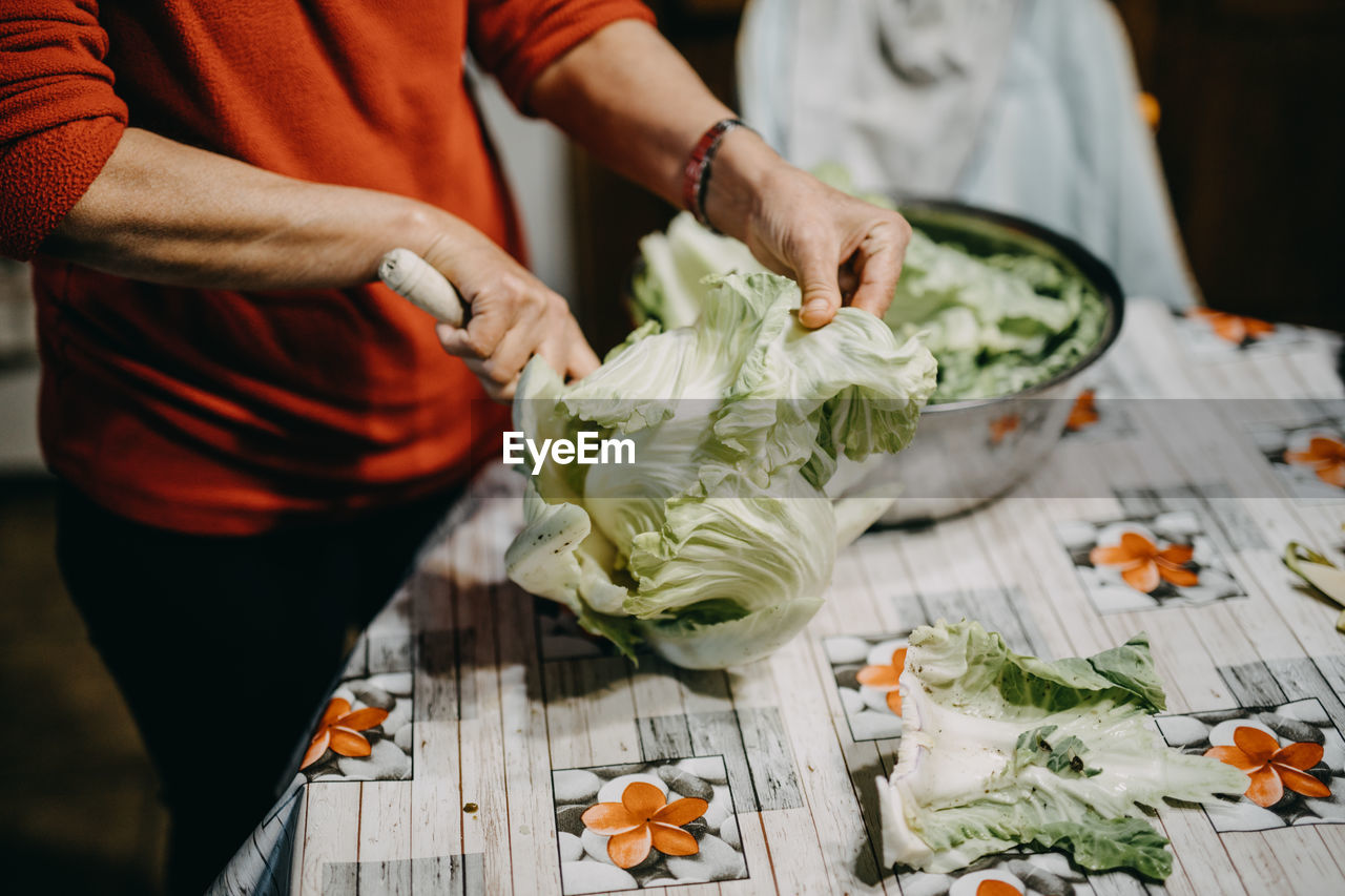 Midsection of man preparing food on table