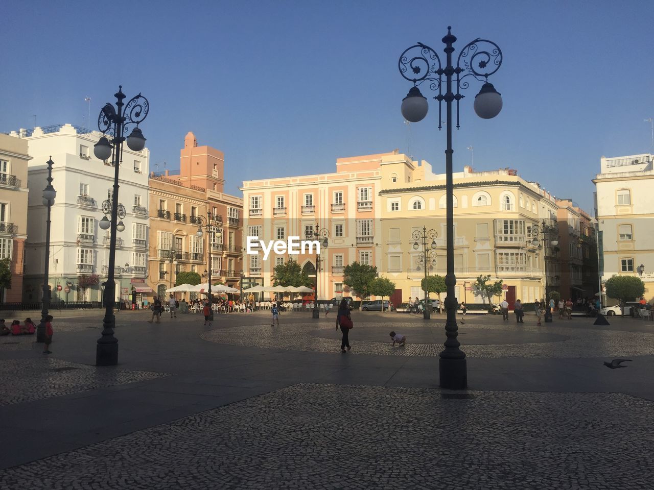 People on street in city against clear sky