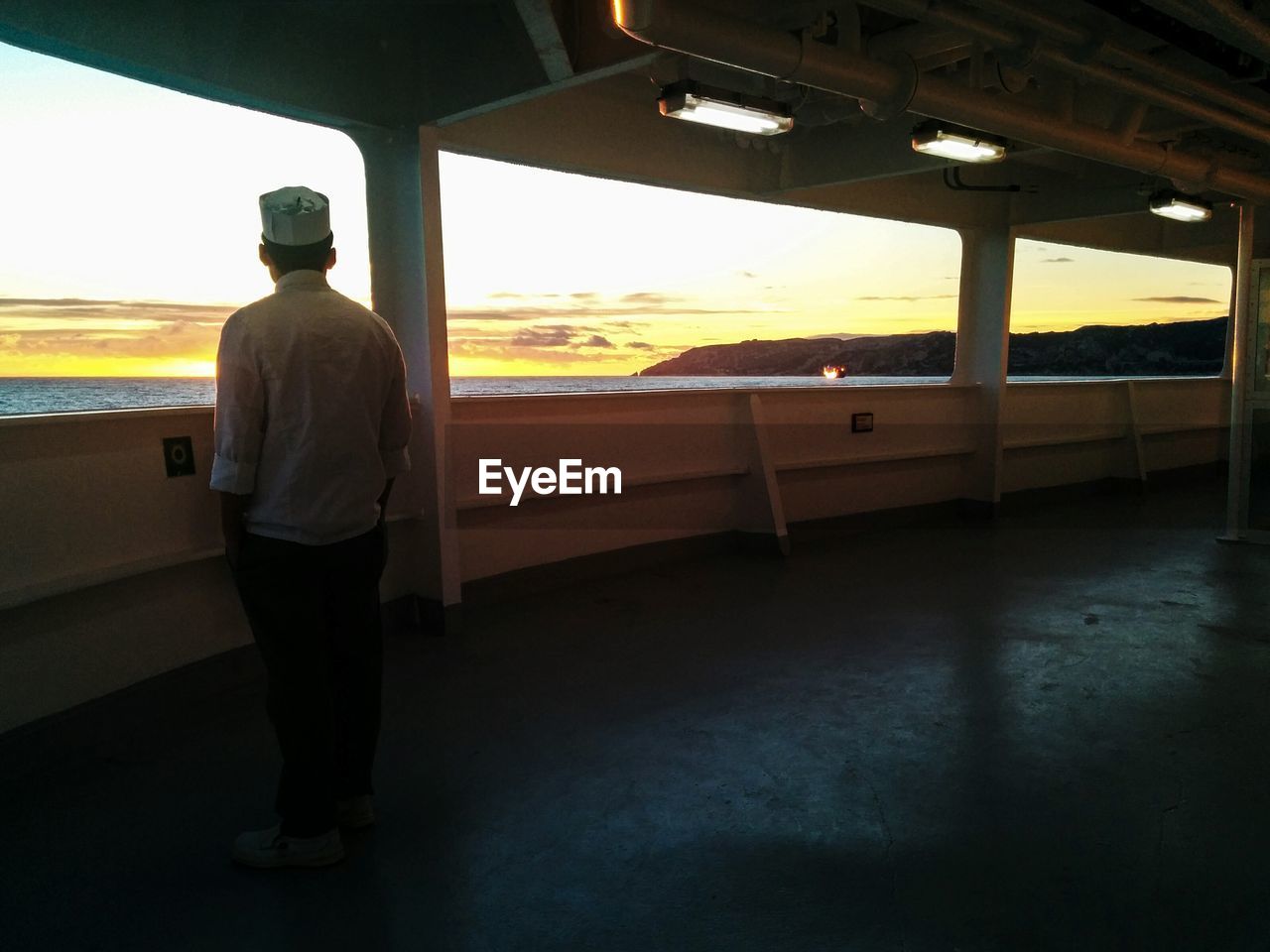 Rear view of man looking at sunset view