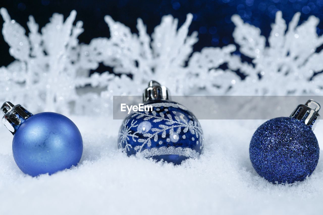 Close-up of christmas decorations on snow