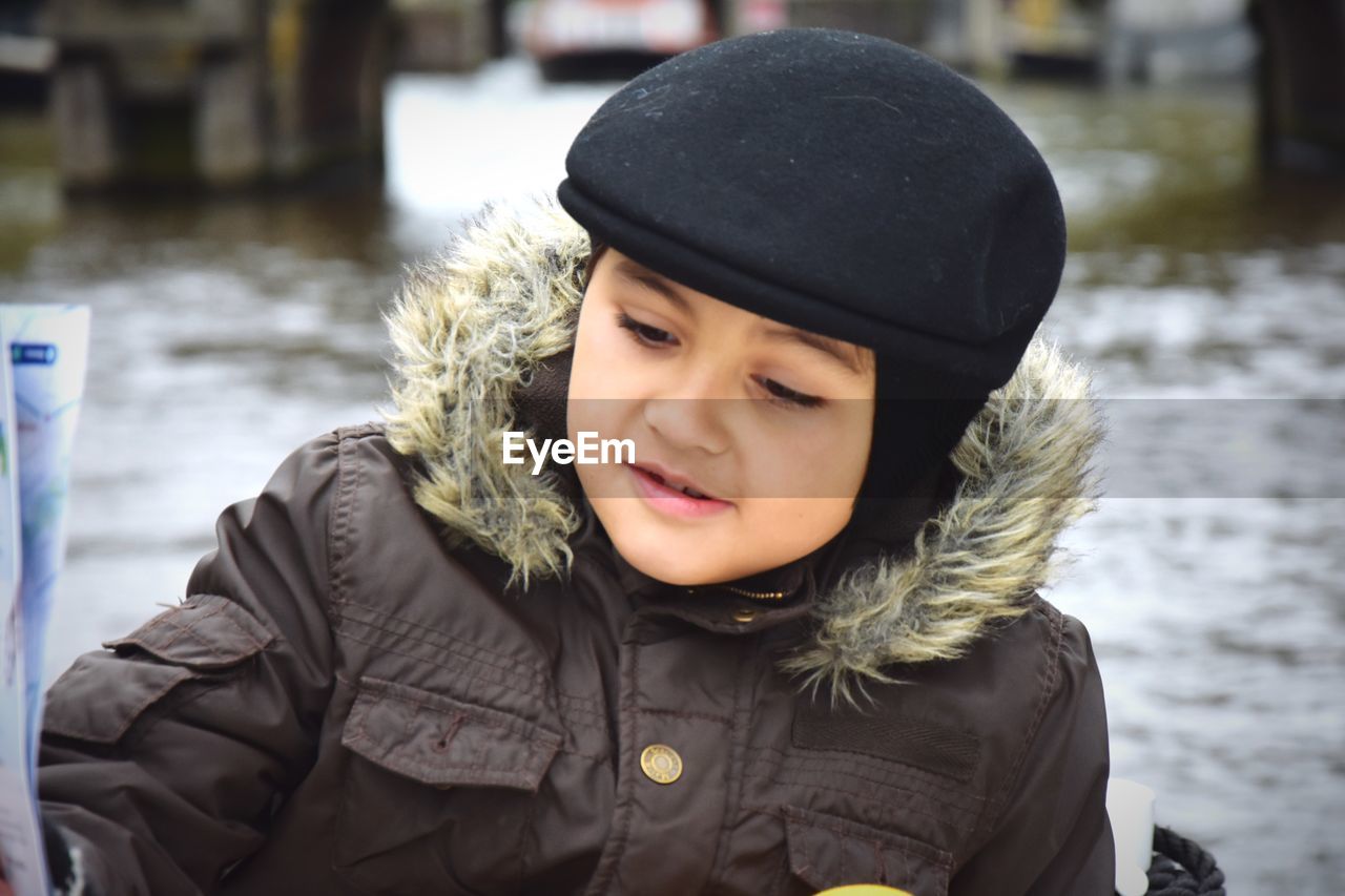 Portrait of boy in warm clothing looking away