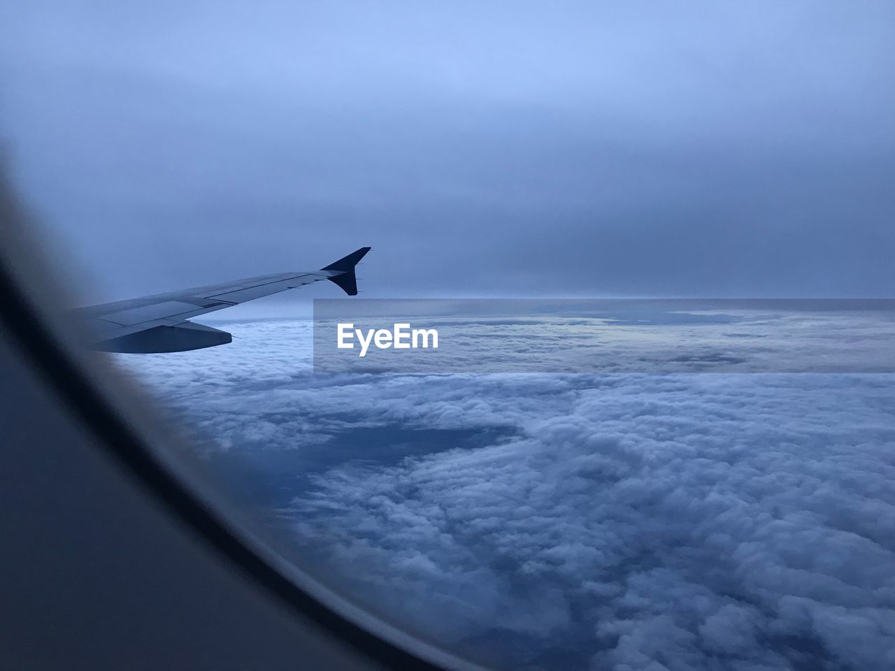 Airplane flying over cloudscape against sky