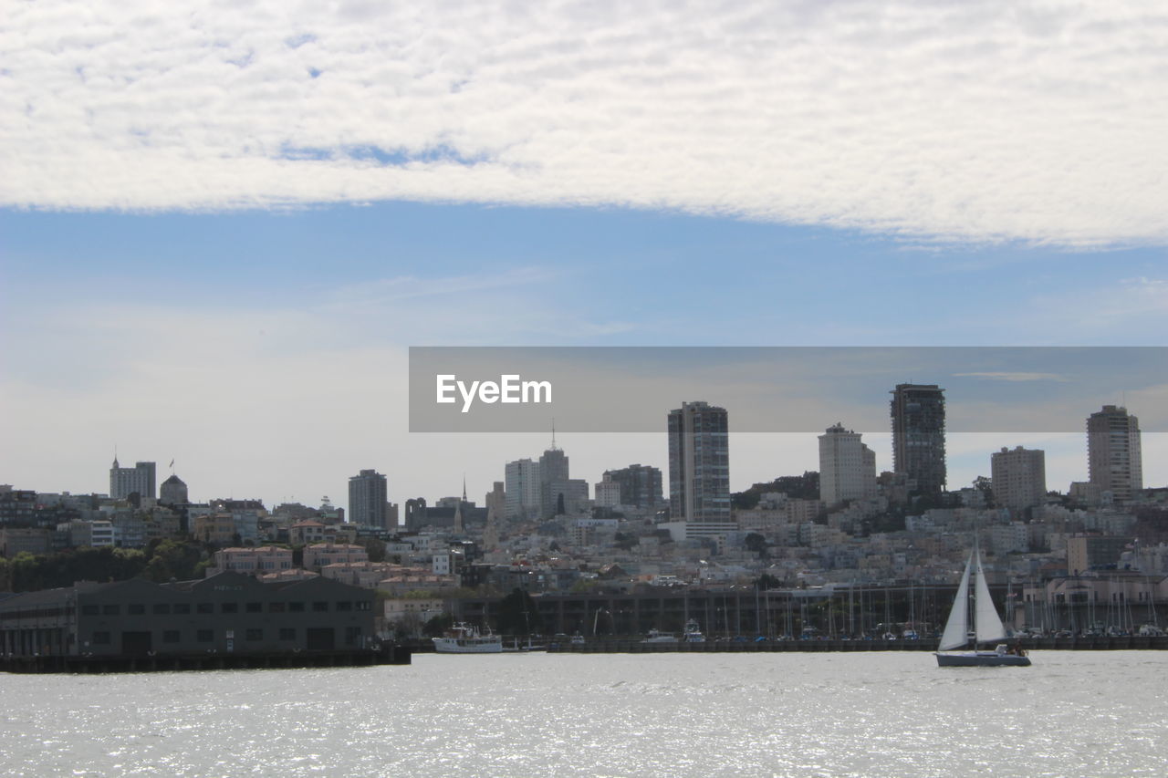 BUILDINGS BY SEA AGAINST SKY