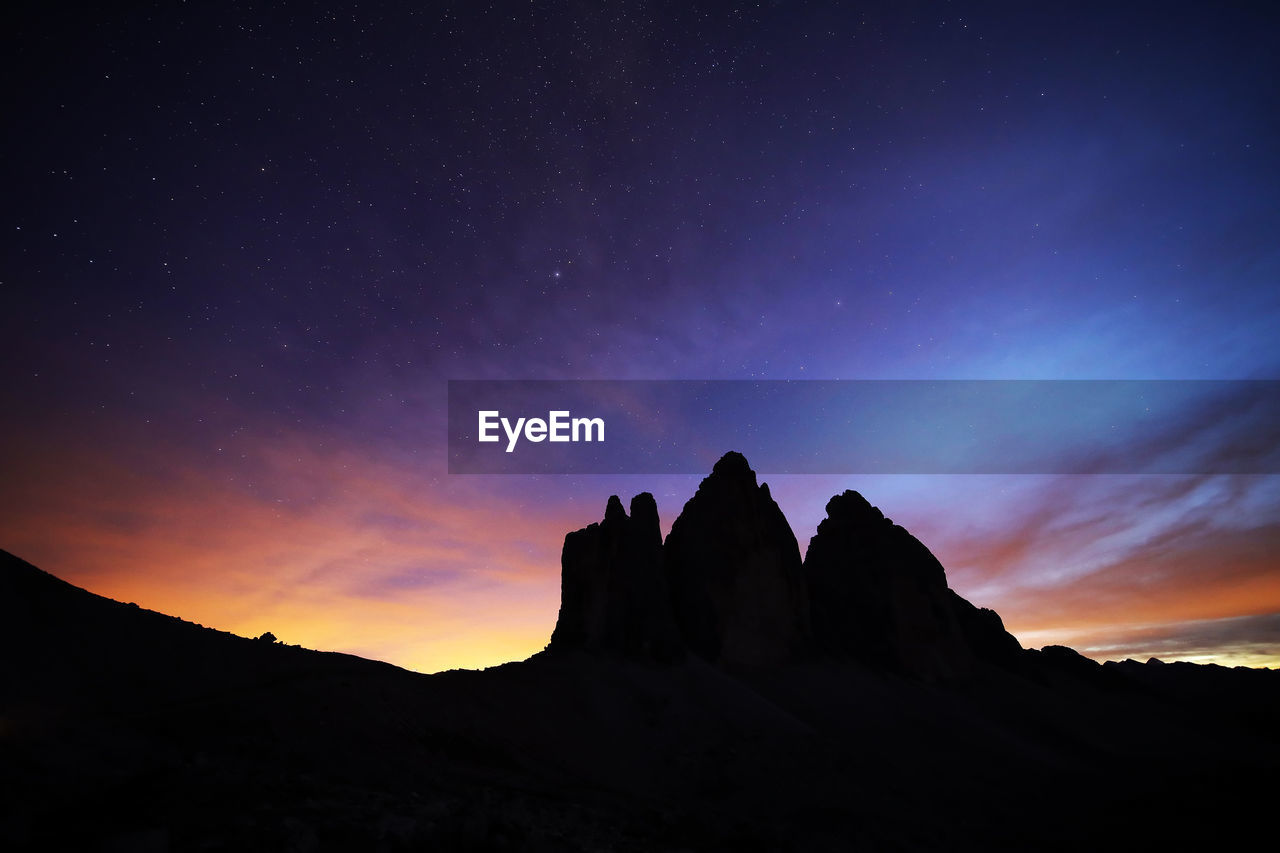 Low angle view of rock formation against sky during dusk