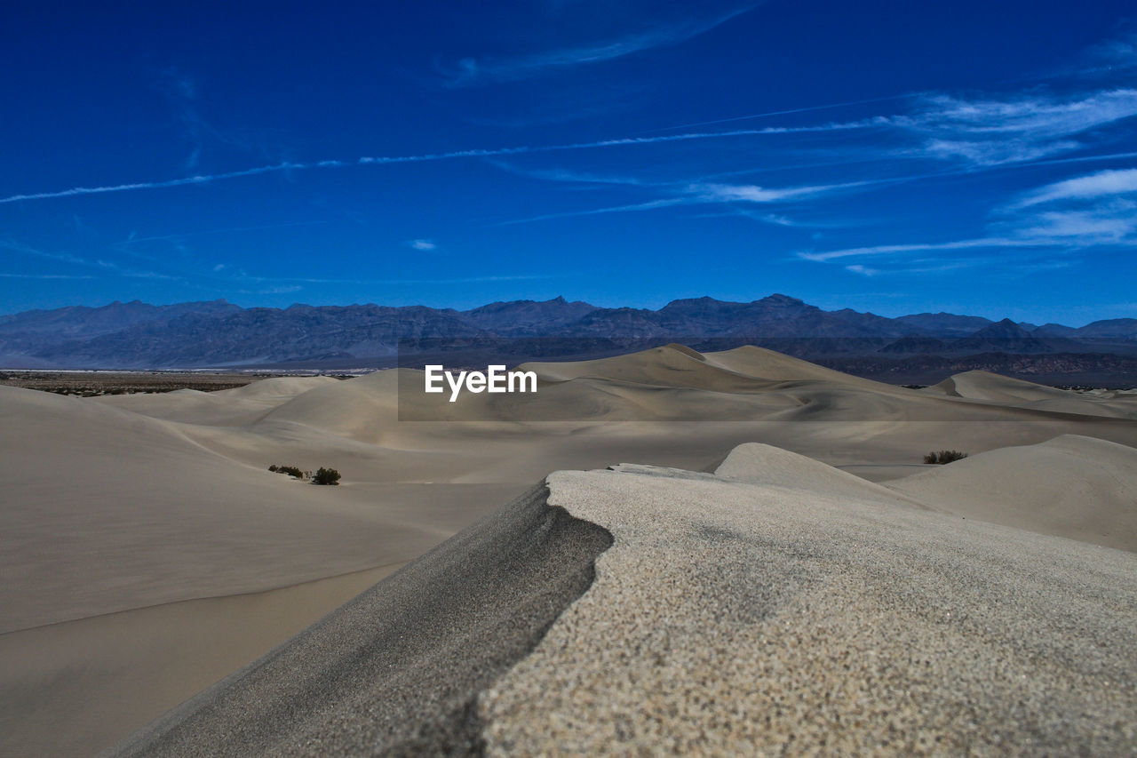 Scenic view of dramatic landscape against blue sky