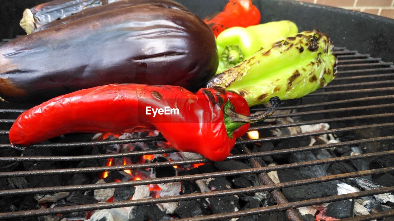 Red chili pepper and eggplant on barbecue grill