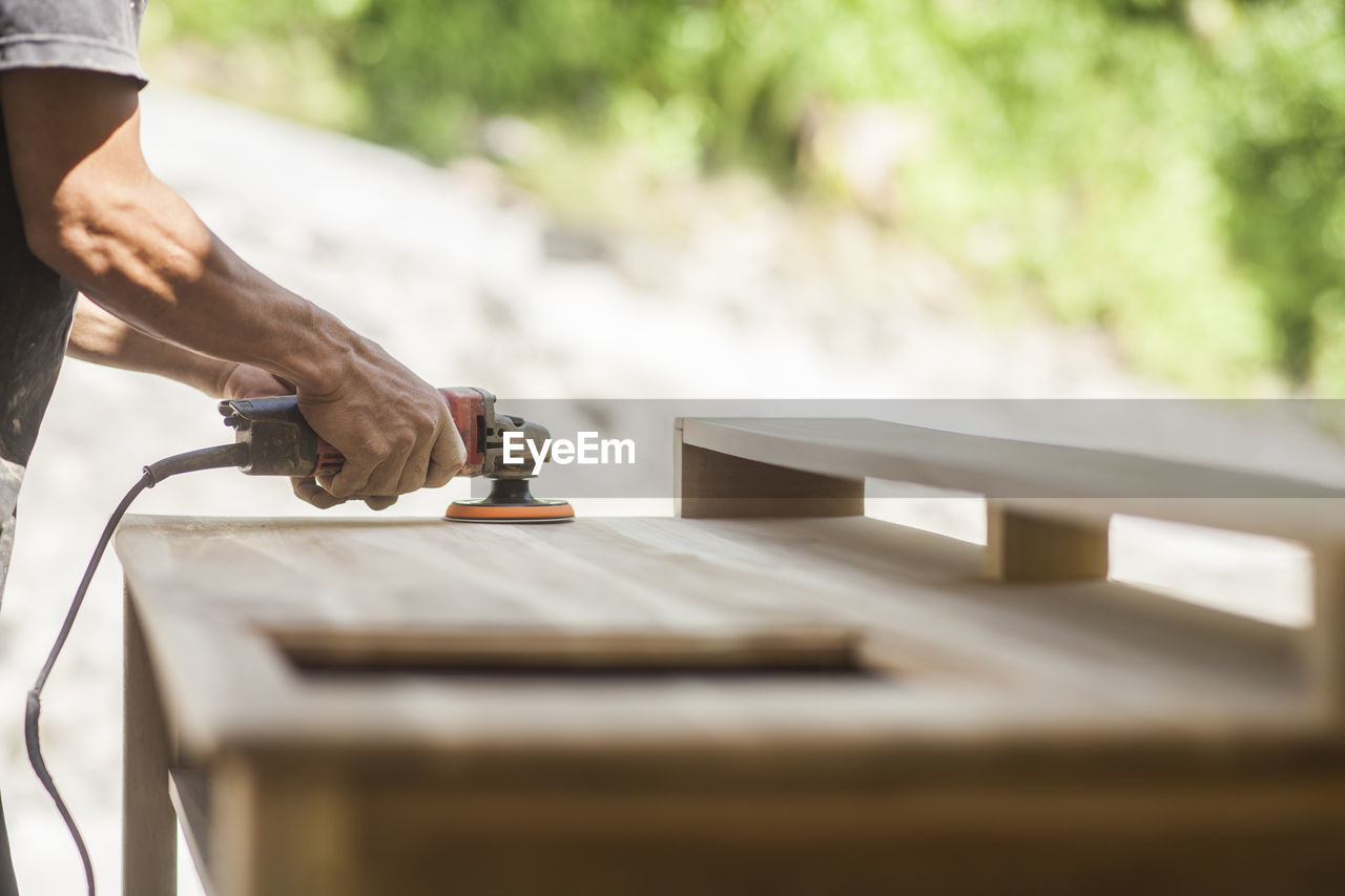 cropped image of man working at workshop