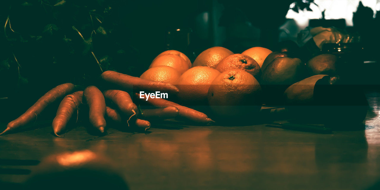 food and drink, food, healthy eating, wellbeing, darkness, freshness, indoors, light, orange color, fruit, still life photography, table, no people, red, reflection