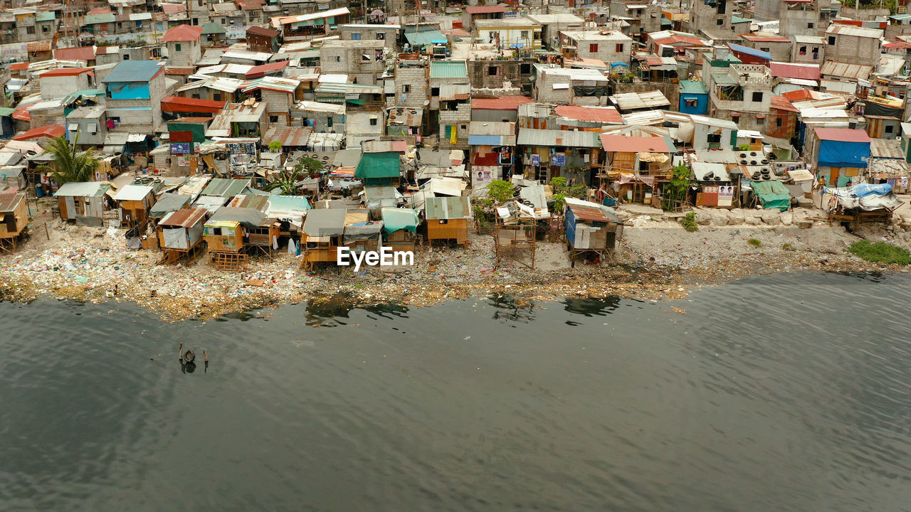 Poor district and slums in manila with shacks and buildings. manila, philippines.