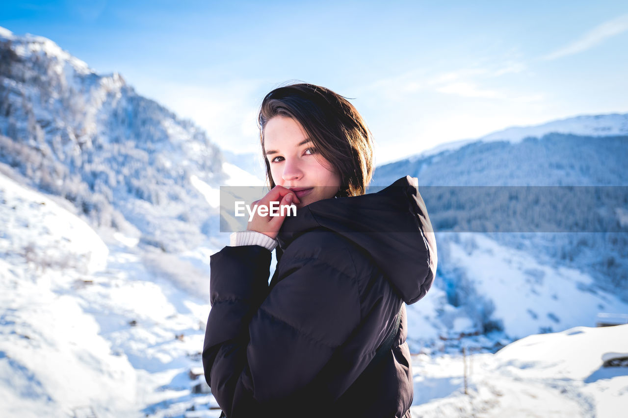 Young woman standing on snow covered mountain