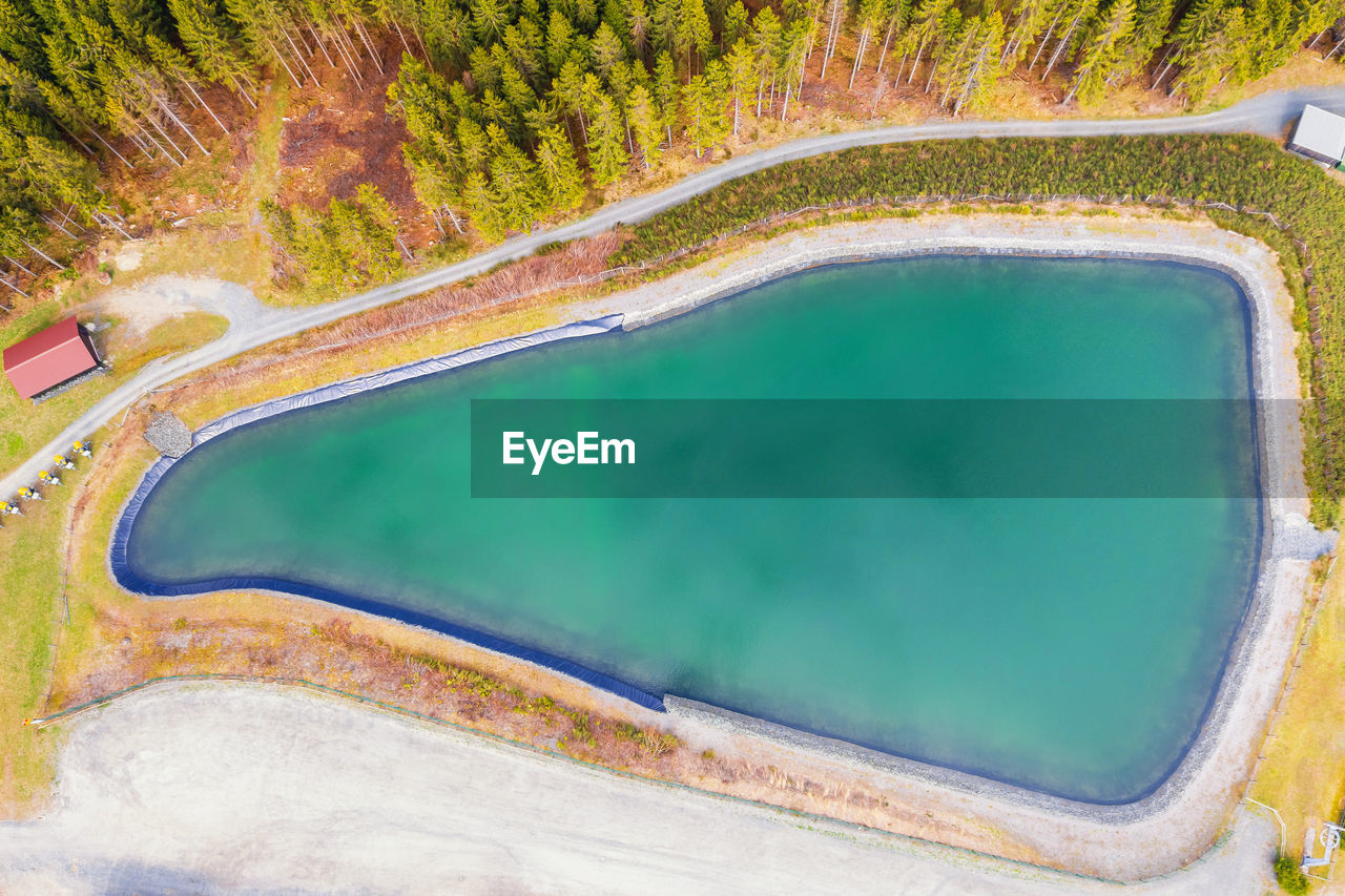 HIGH ANGLE VIEW OF SWIMMING POOL IN THE LANDSCAPE