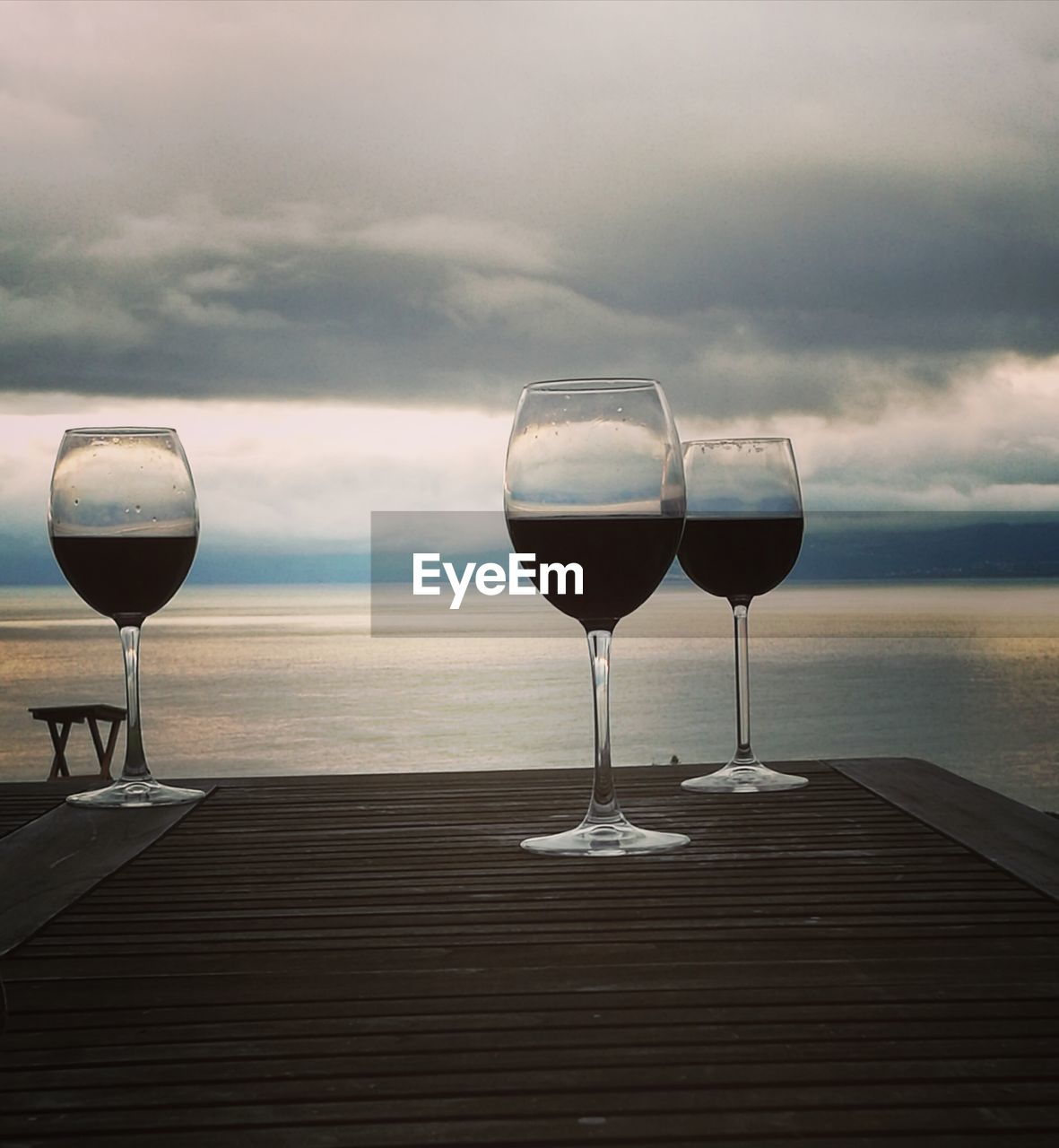 Wineglass on jetty by sea