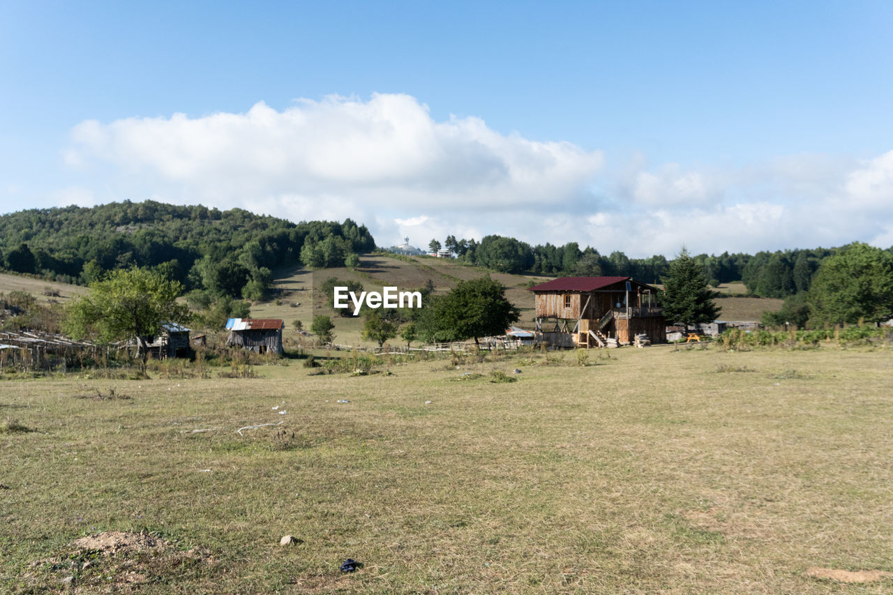 Houses on field against sky