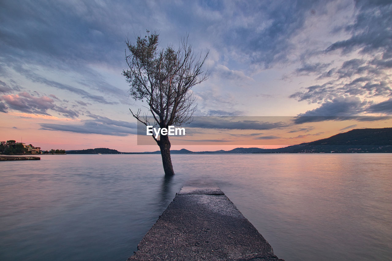 Scenic view of lake against sky during sunset