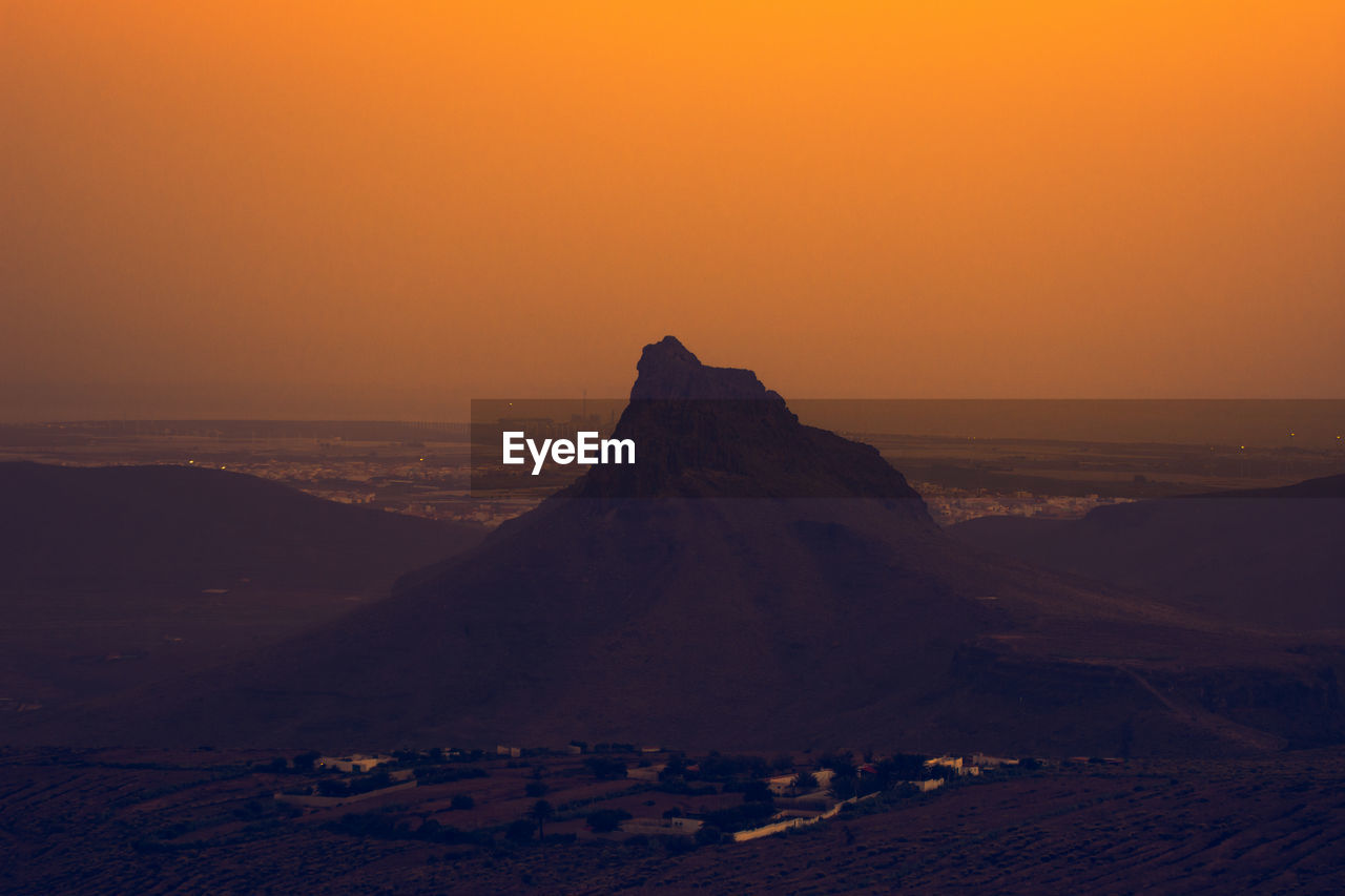 Scenic view of sea against clear sky during sunset