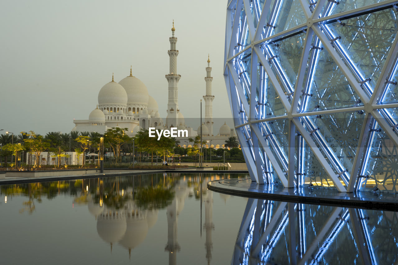 architecture, built structure, reflection, dome, water, building exterior, landmark, travel destinations, religion, place of worship, sky, belief, building, nature, travel, tourism, city, spirituality, no people, outdoors, lake, tower, history, construction industry, cityscape