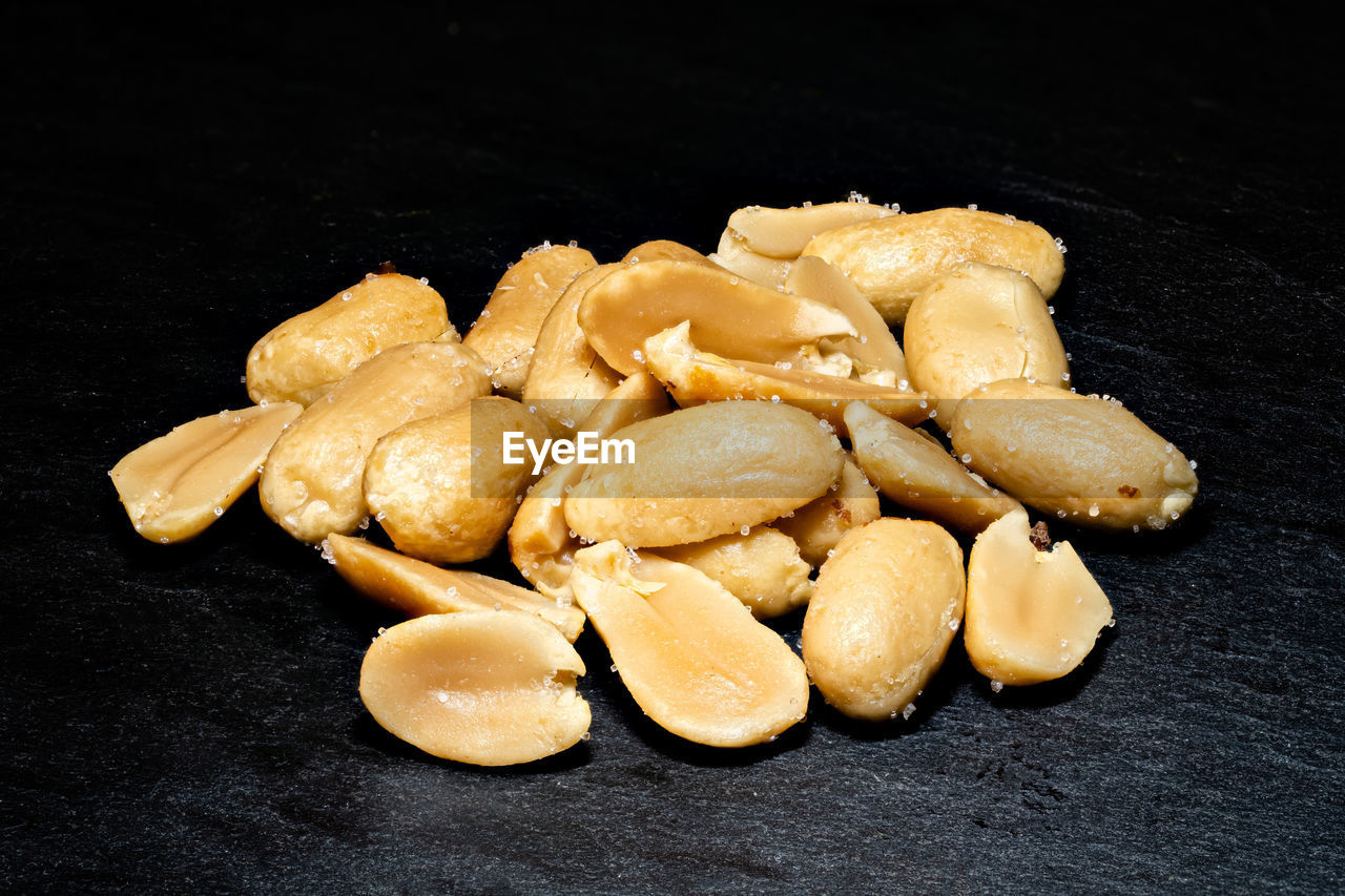 Peeled peanuts on dark background