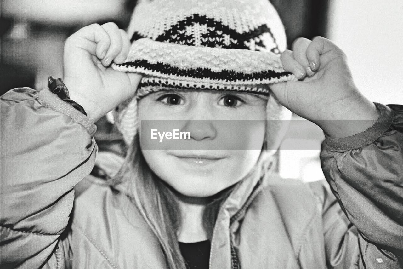 Close-up portrait of innocent girl in knit hat