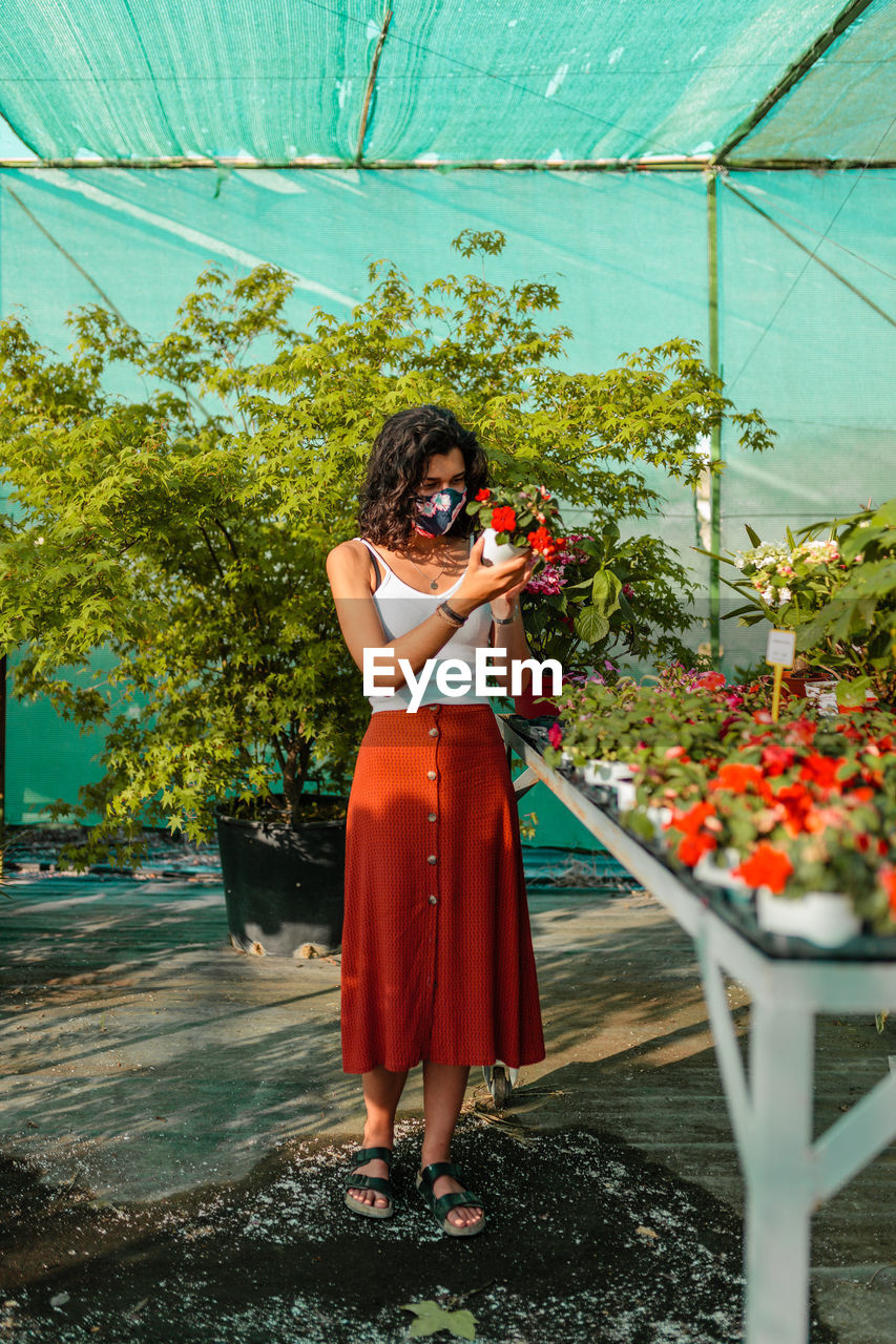 Woman looking at flowering plants