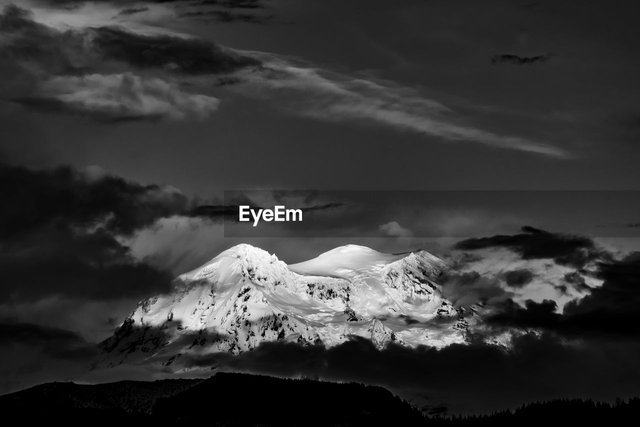 Low angle view of mountain against dramatic sky