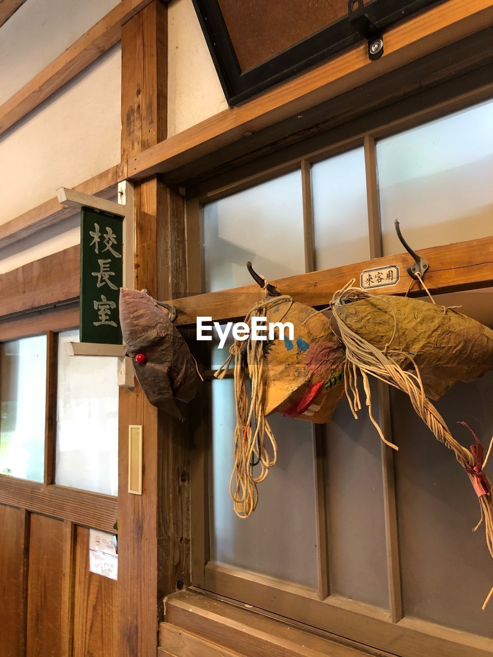 LOW ANGLE VIEW OF CAT BY WINDOW IN STABLE