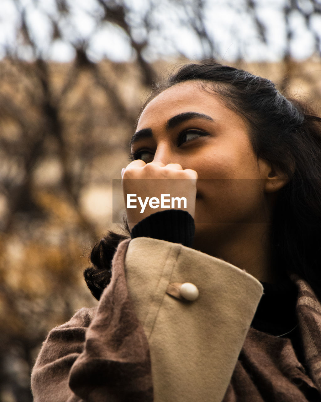 Side view of young woman using mobile phone