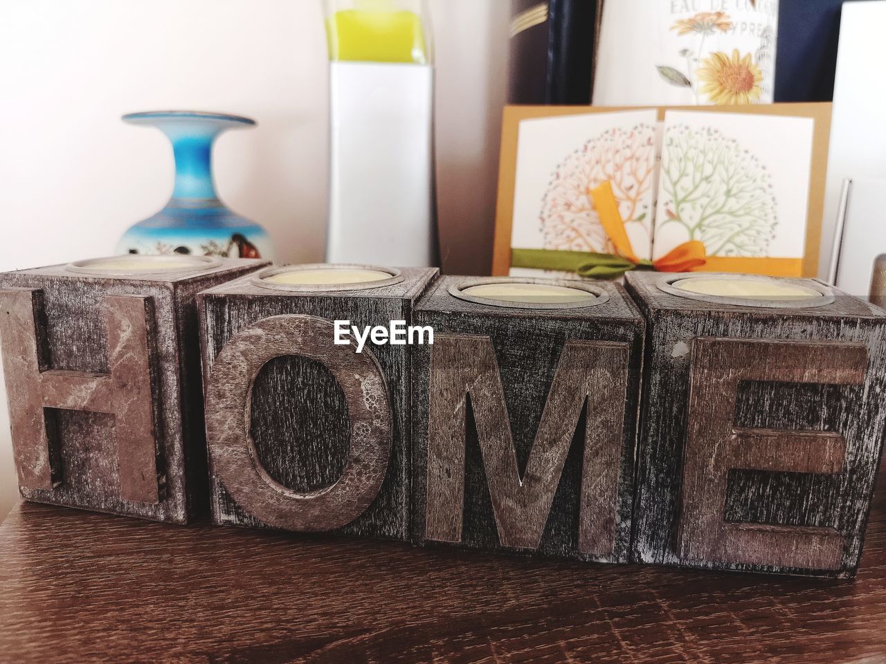 Close-up of text made with toy blocks against decorations on table