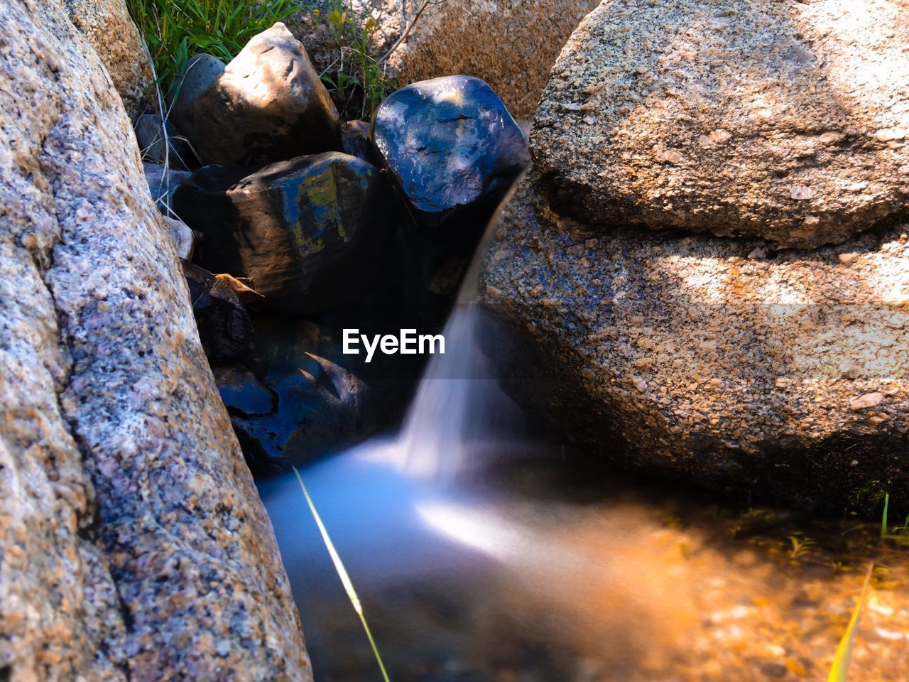 ROCK FORMATIONS IN WATER AT SHORE