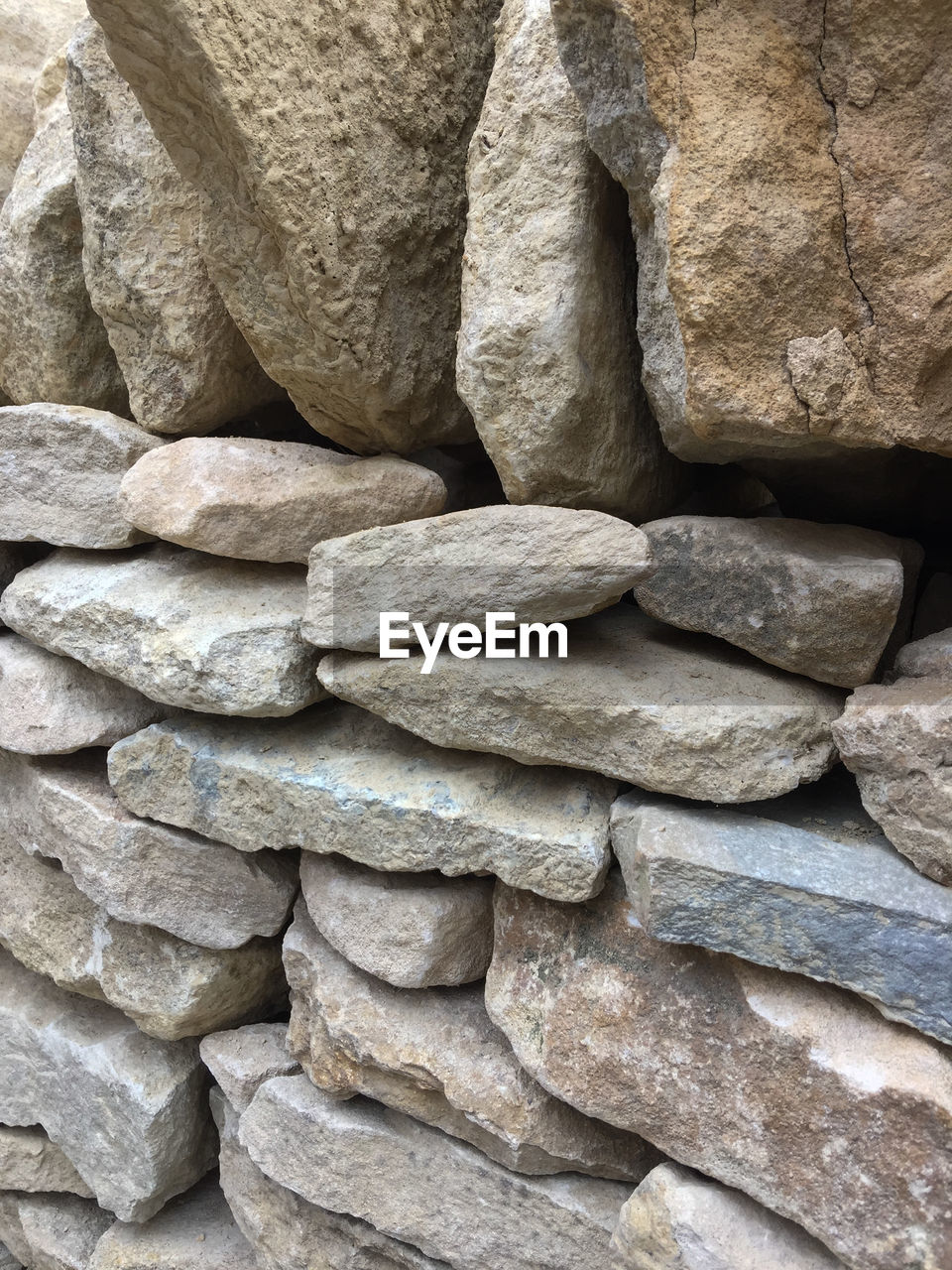 FULL FRAME SHOT OF STACK OF STONE