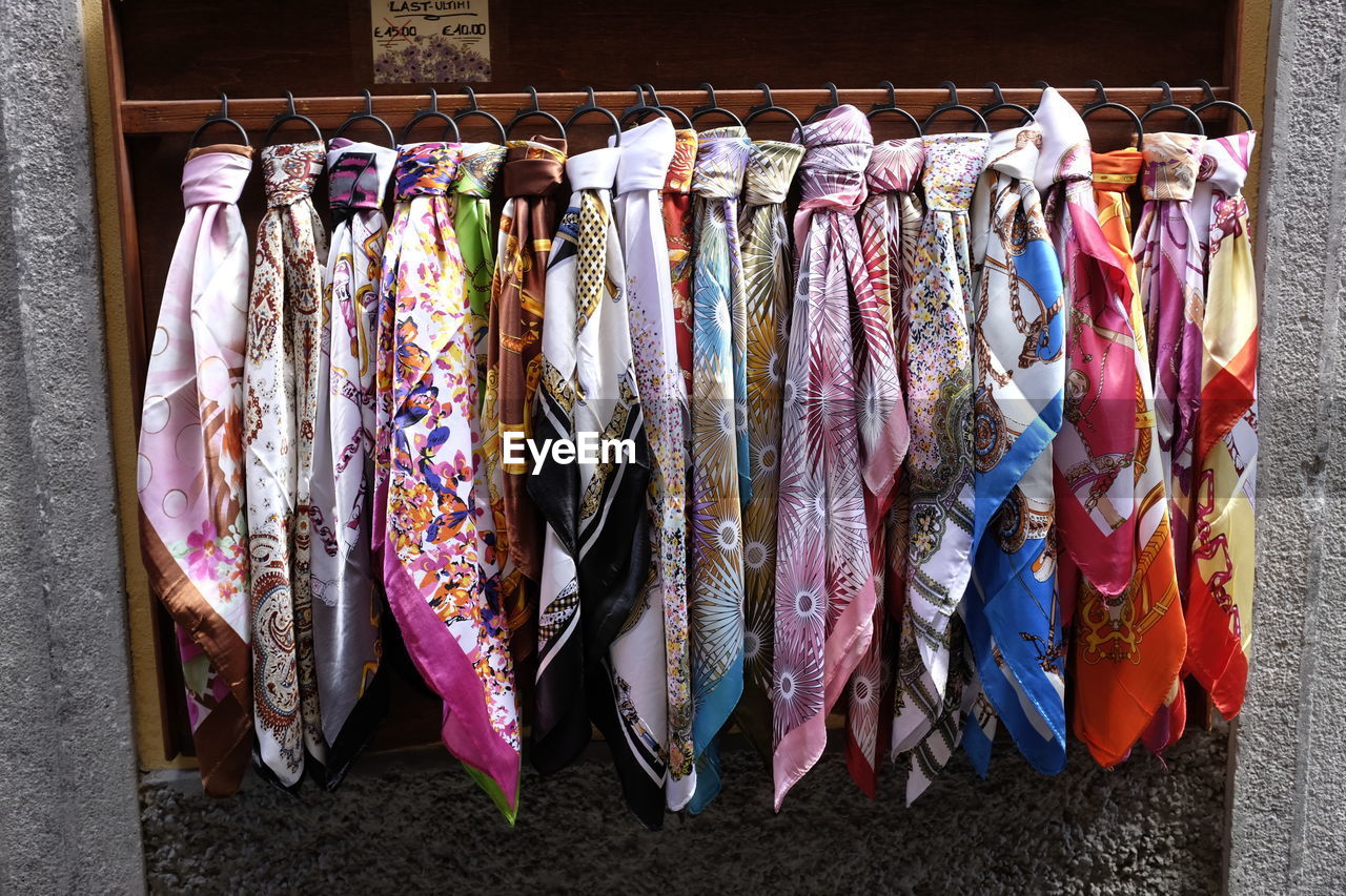 COLORFUL CLOTHES HANGING IN MARKET