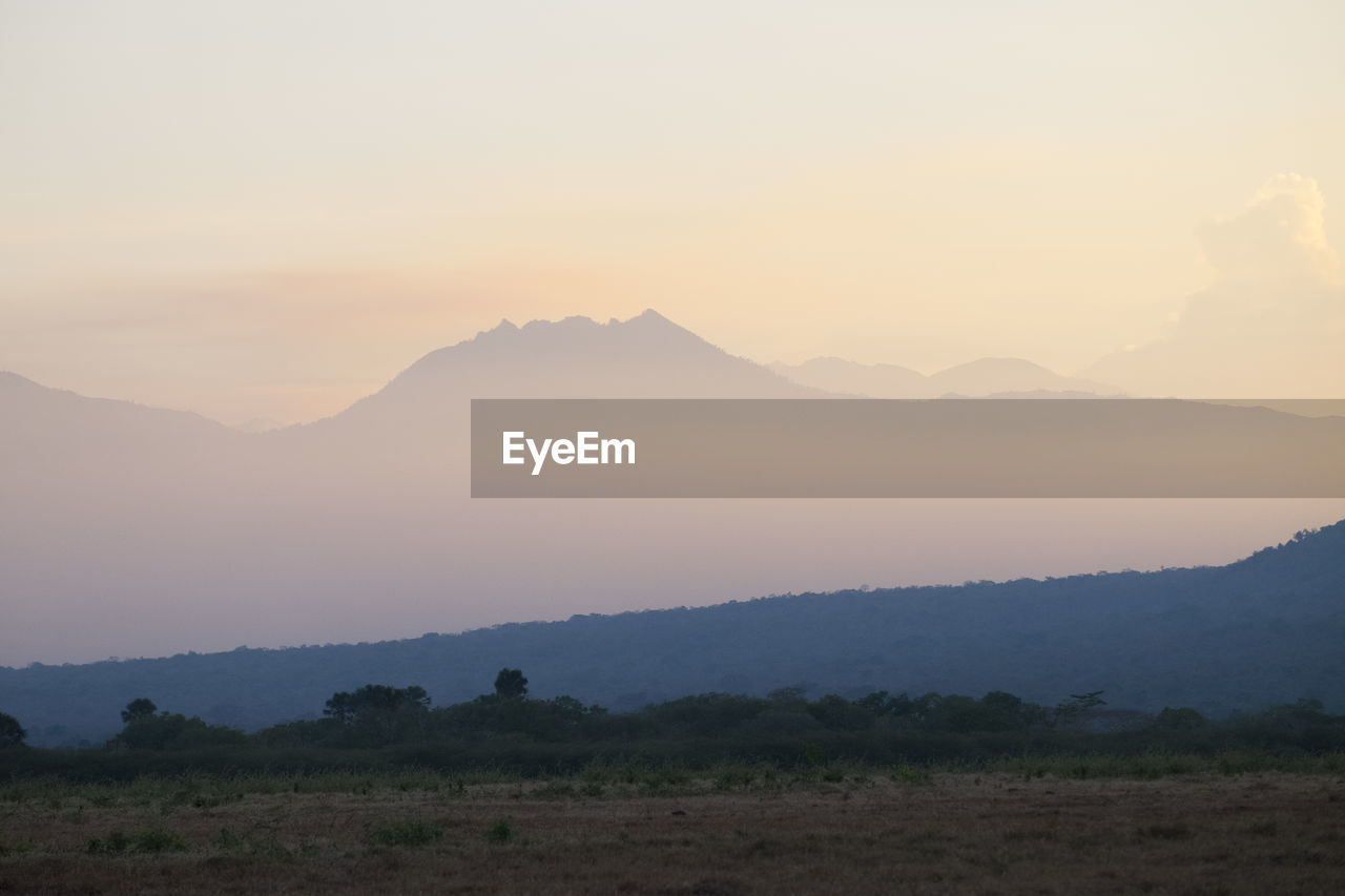 SCENIC VIEW OF MOUNTAIN AGAINST SKY DURING SUNSET