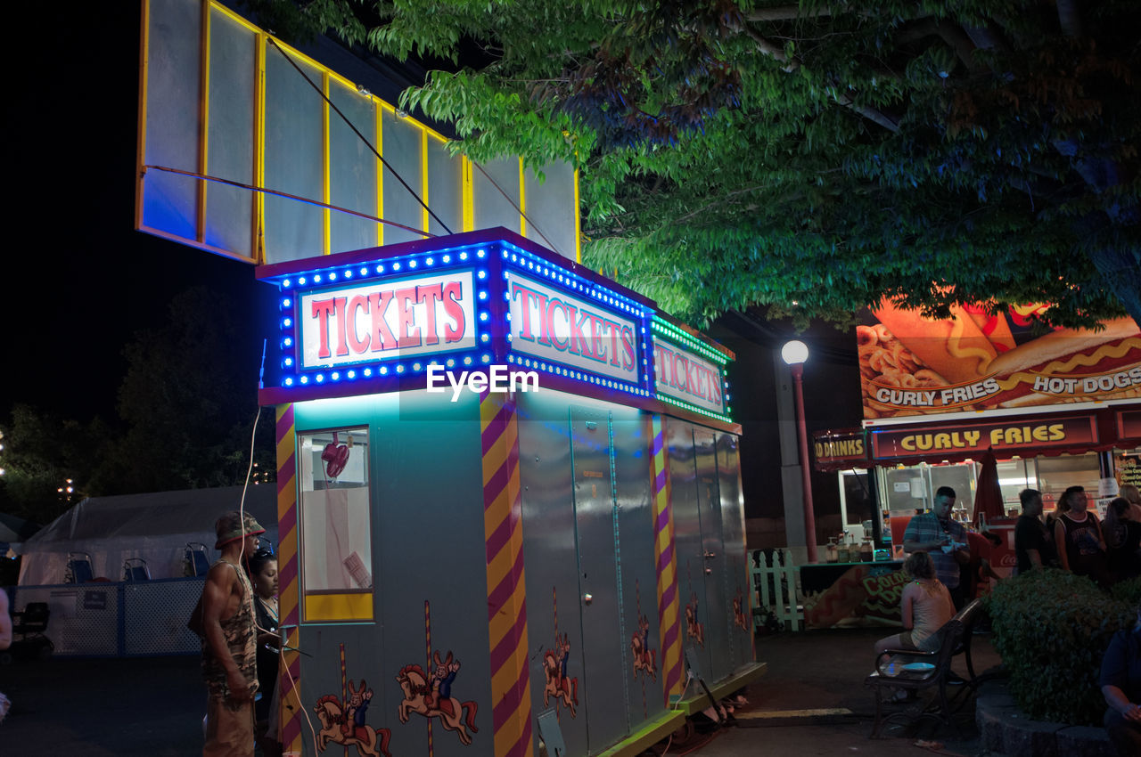 VIEW OF ILLUMINATED CITY AT NIGHT