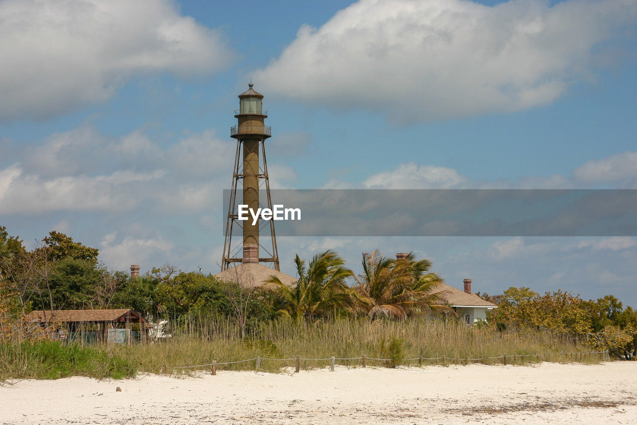 lighthouse on field against sky