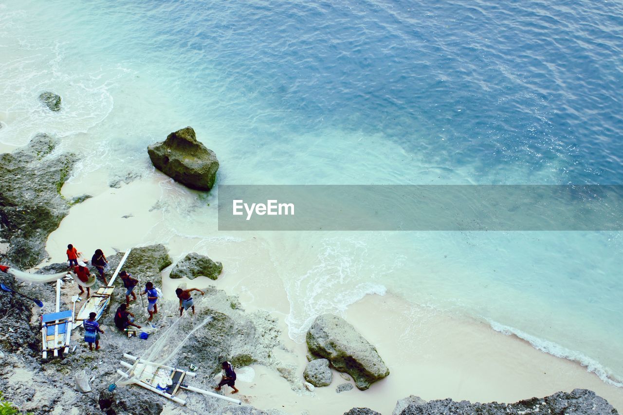 HIGH ANGLE VIEW OF PEOPLE ON BEACH