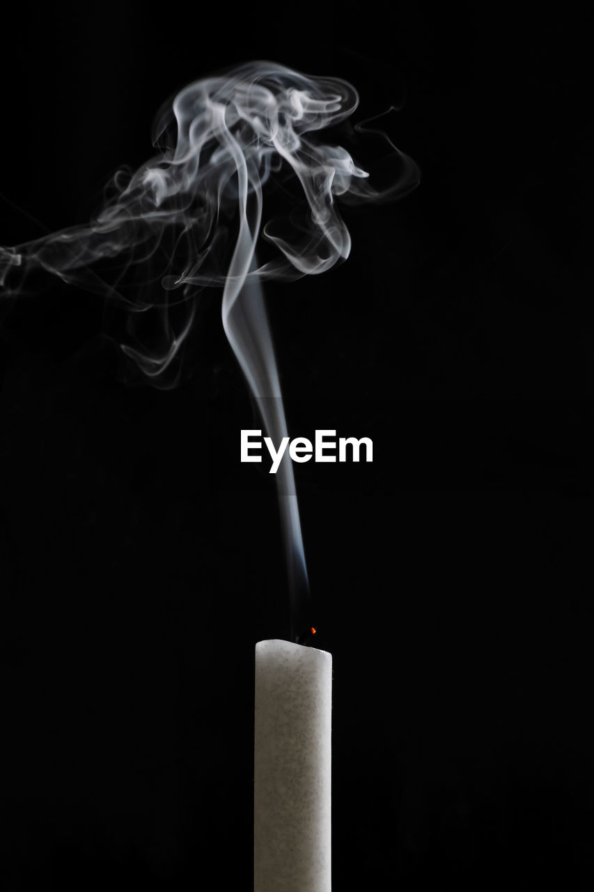 CLOSE-UP OF SMOKE AGAINST BLACK BACKGROUND