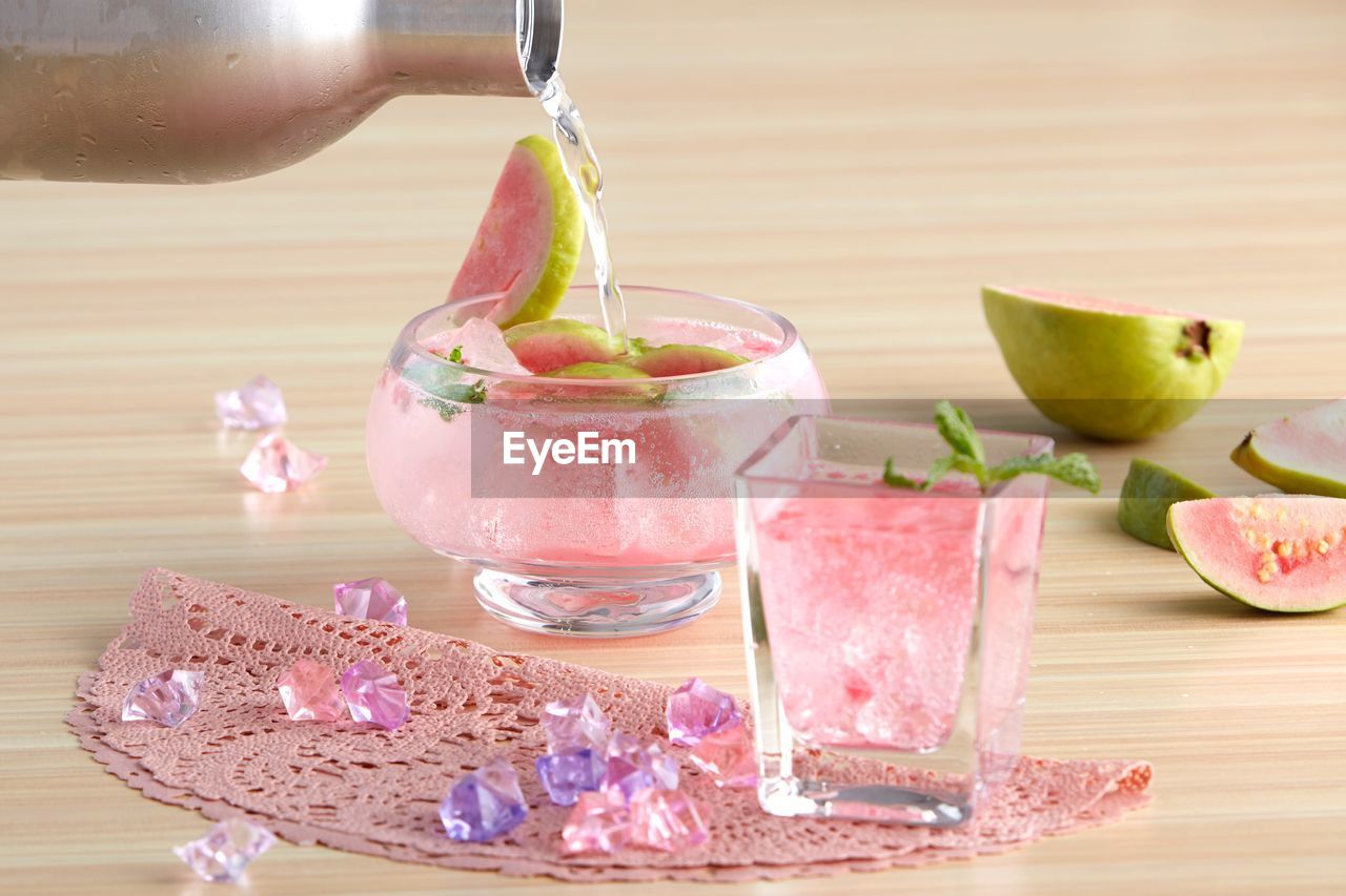 CLOSE-UP OF FRUITS WITH DRINK ON TABLE