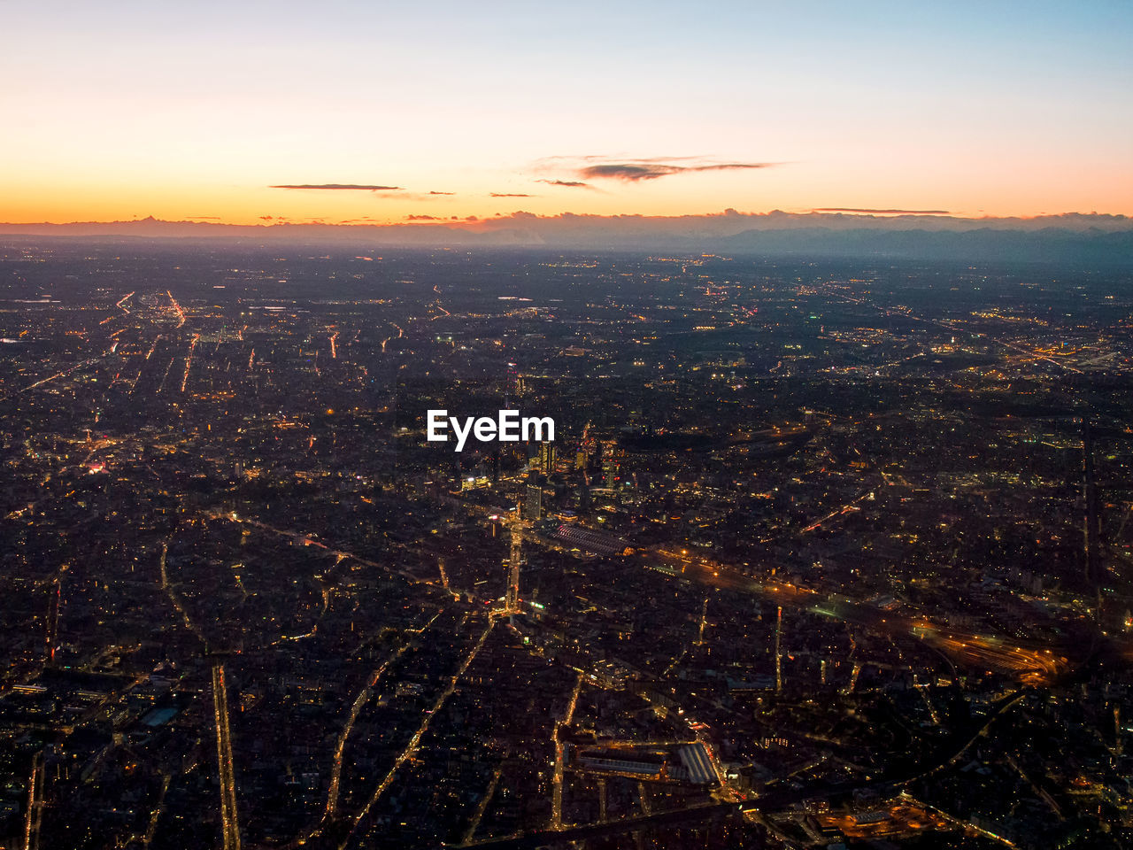 Aerial view of cityscape against sky during sunset