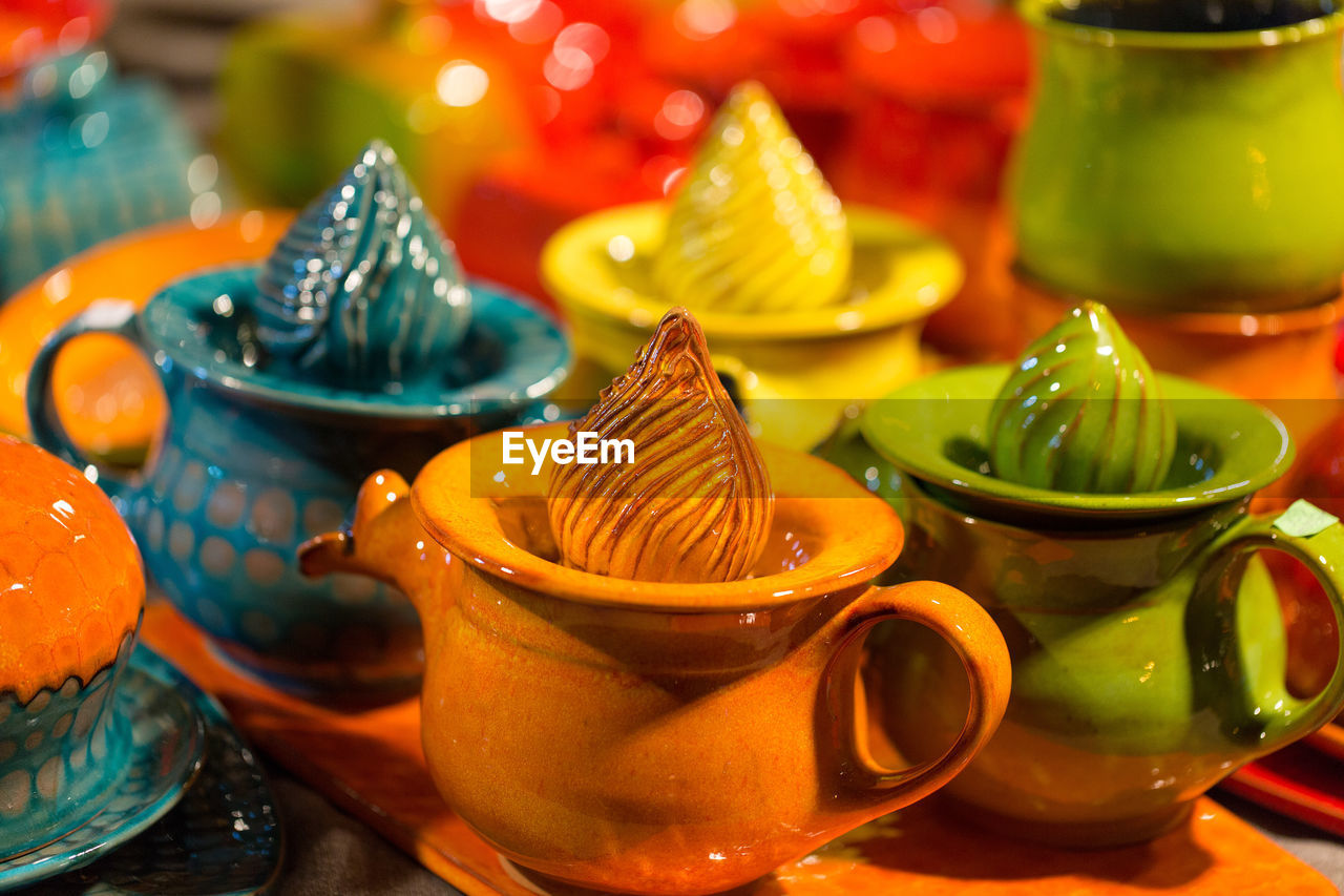 Christmas souvenirs on the counter in europe, glazed ceramic dishes on the market counter.