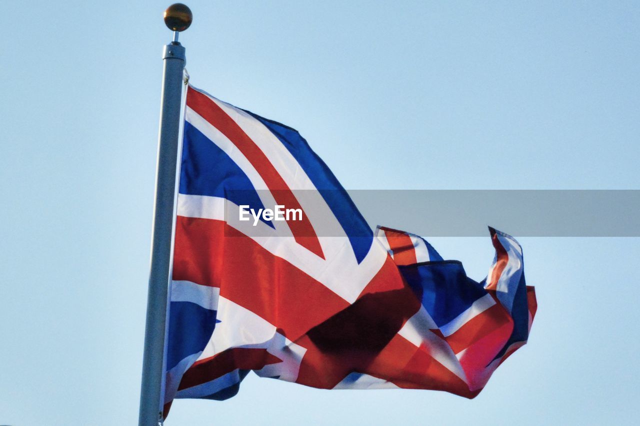 Low angle view of british flag waving against clear sky