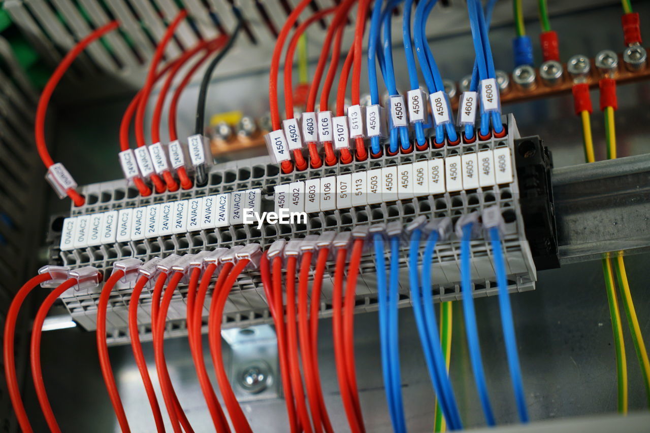Range of electrical modular circuit breakers in electrical cabinet.