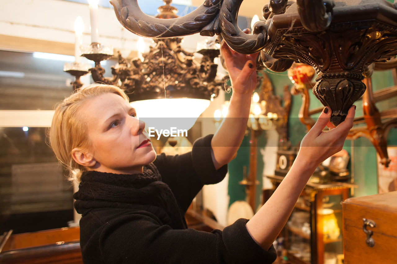 Woman holding antique at store