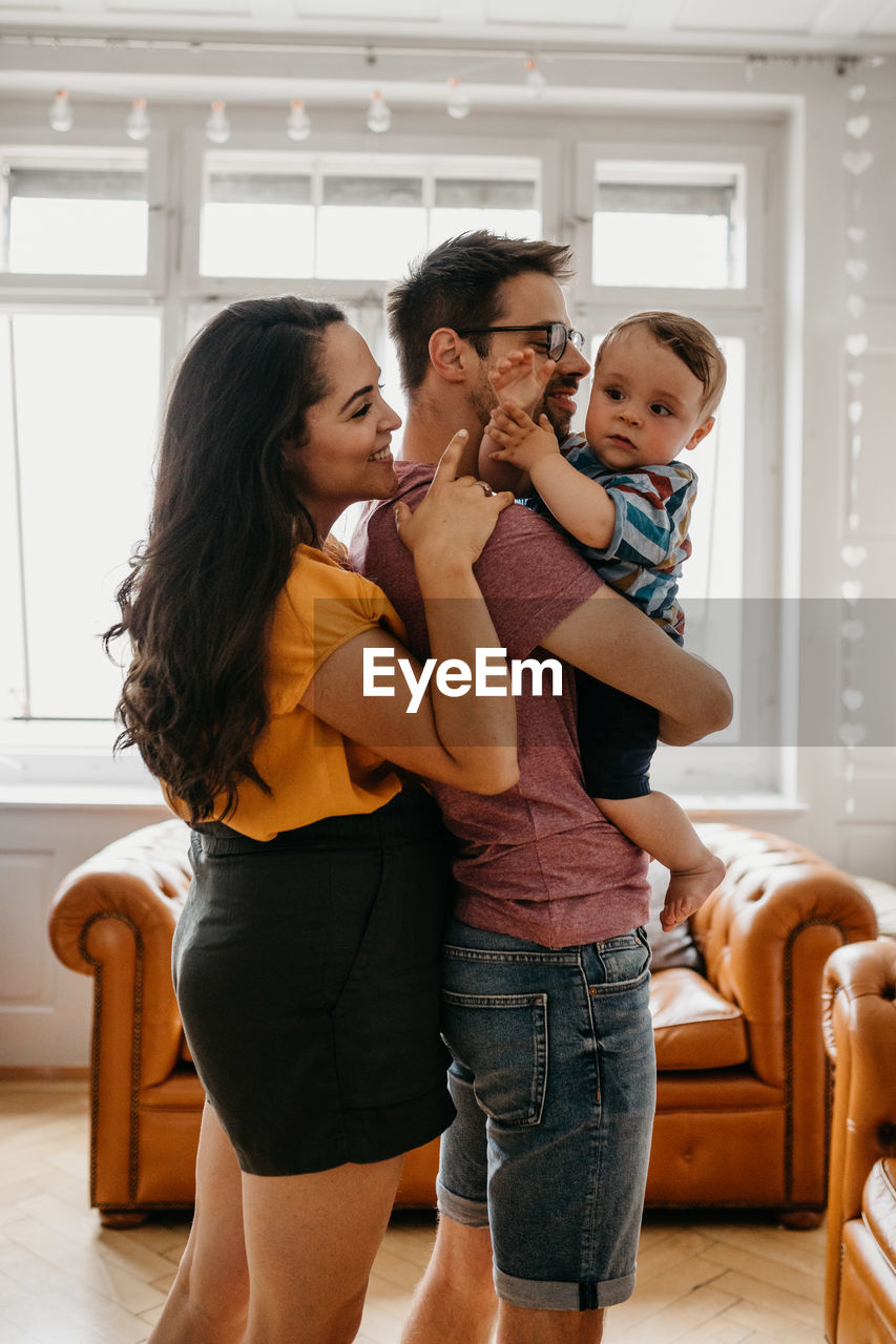 Happy family standing at home