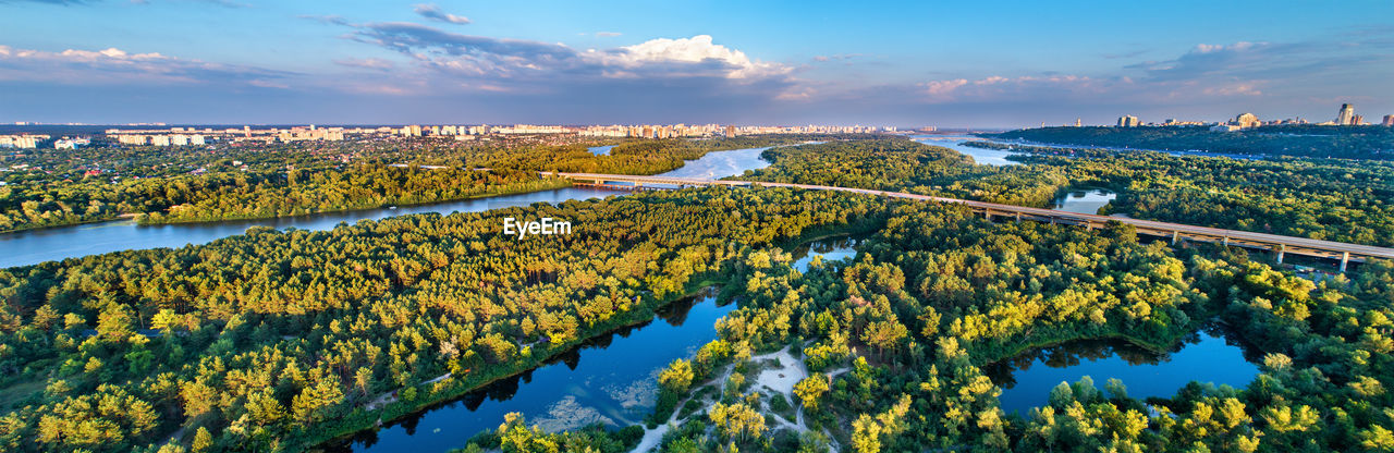 PANORAMIC VIEW OF RIVER AMIDST TREES AGAINST SKY